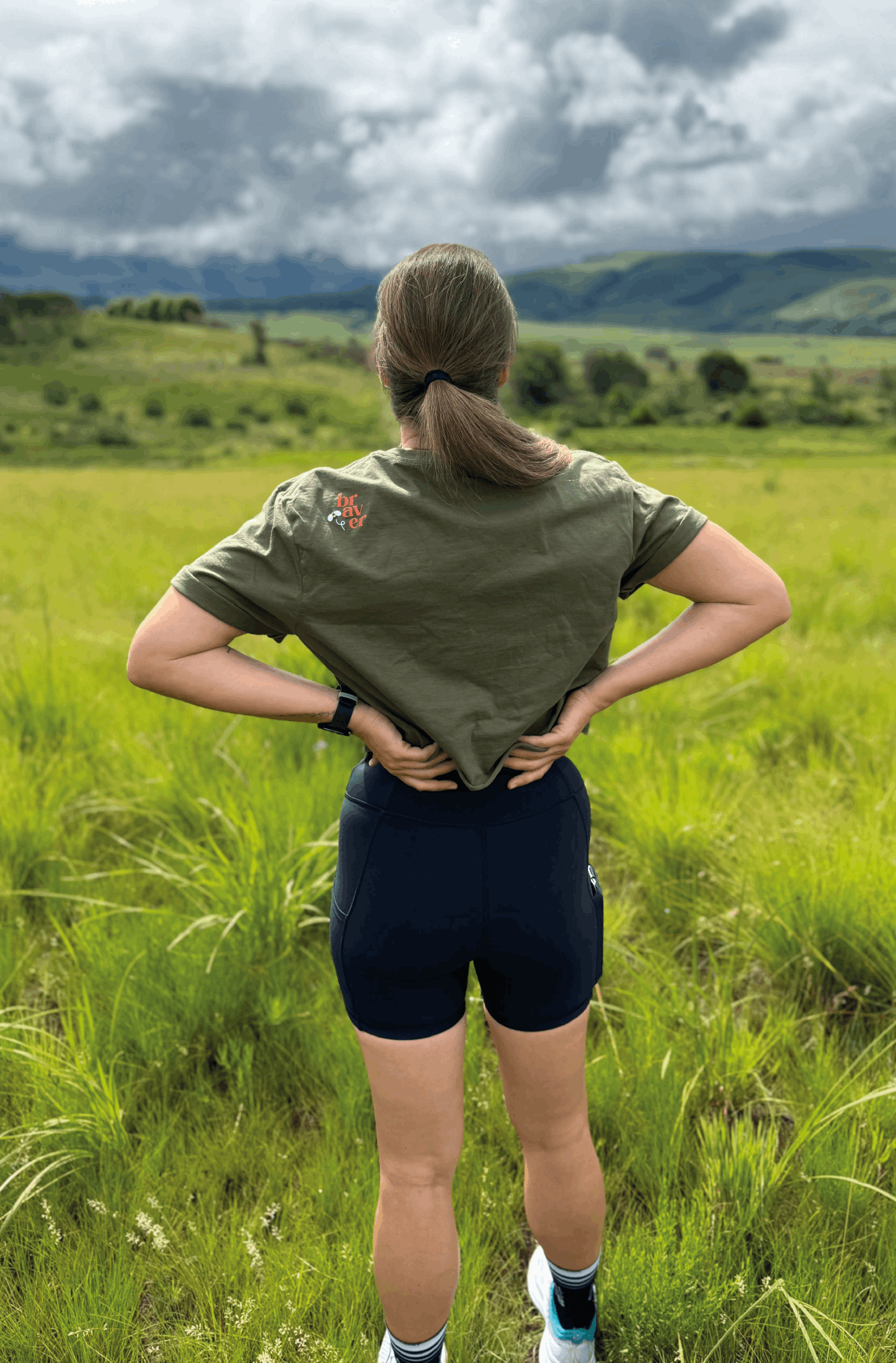 Braver woman wears a crop top with "she is stronger" design in the front
