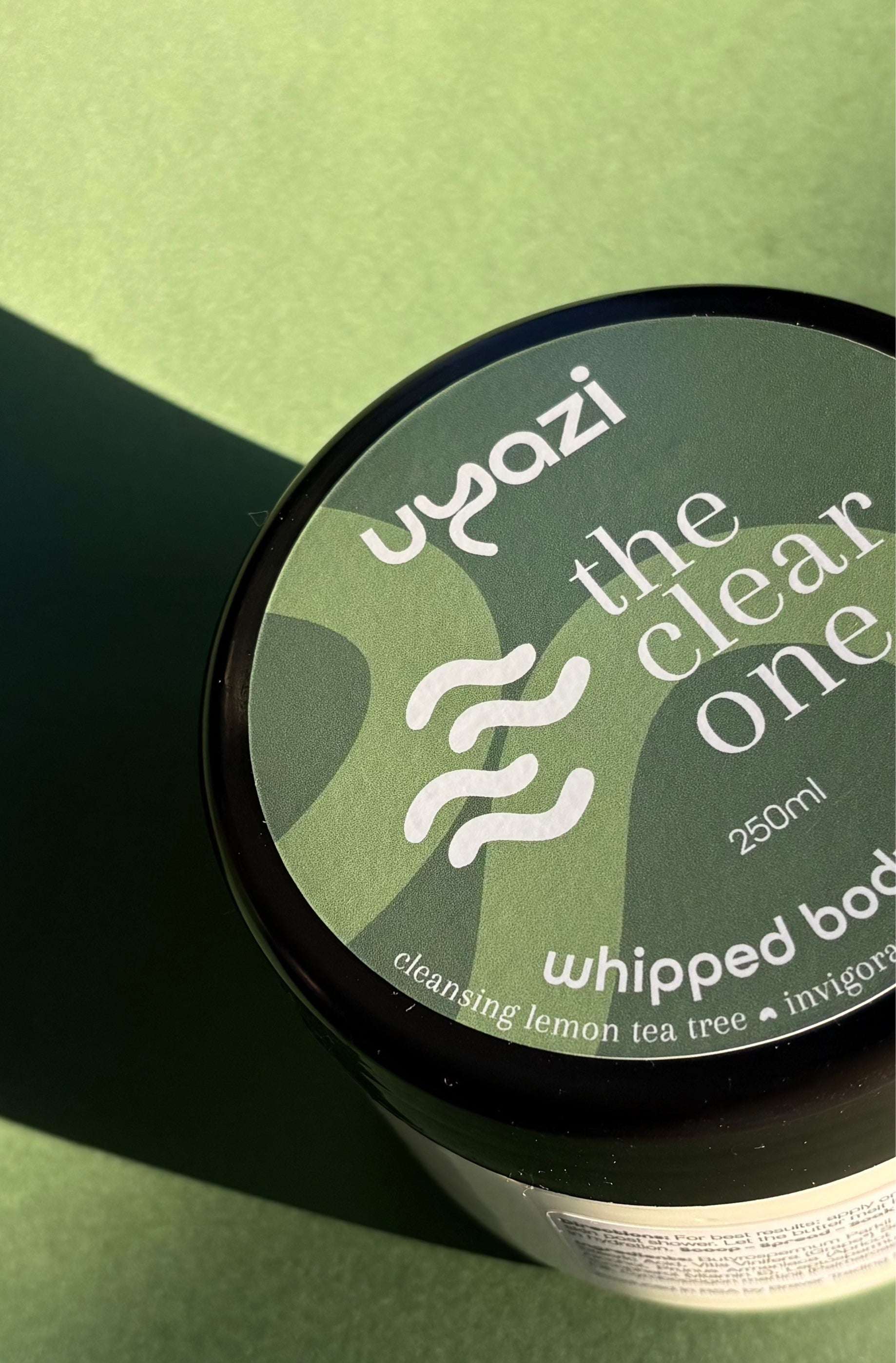 Uyazi whipped body product on a green background