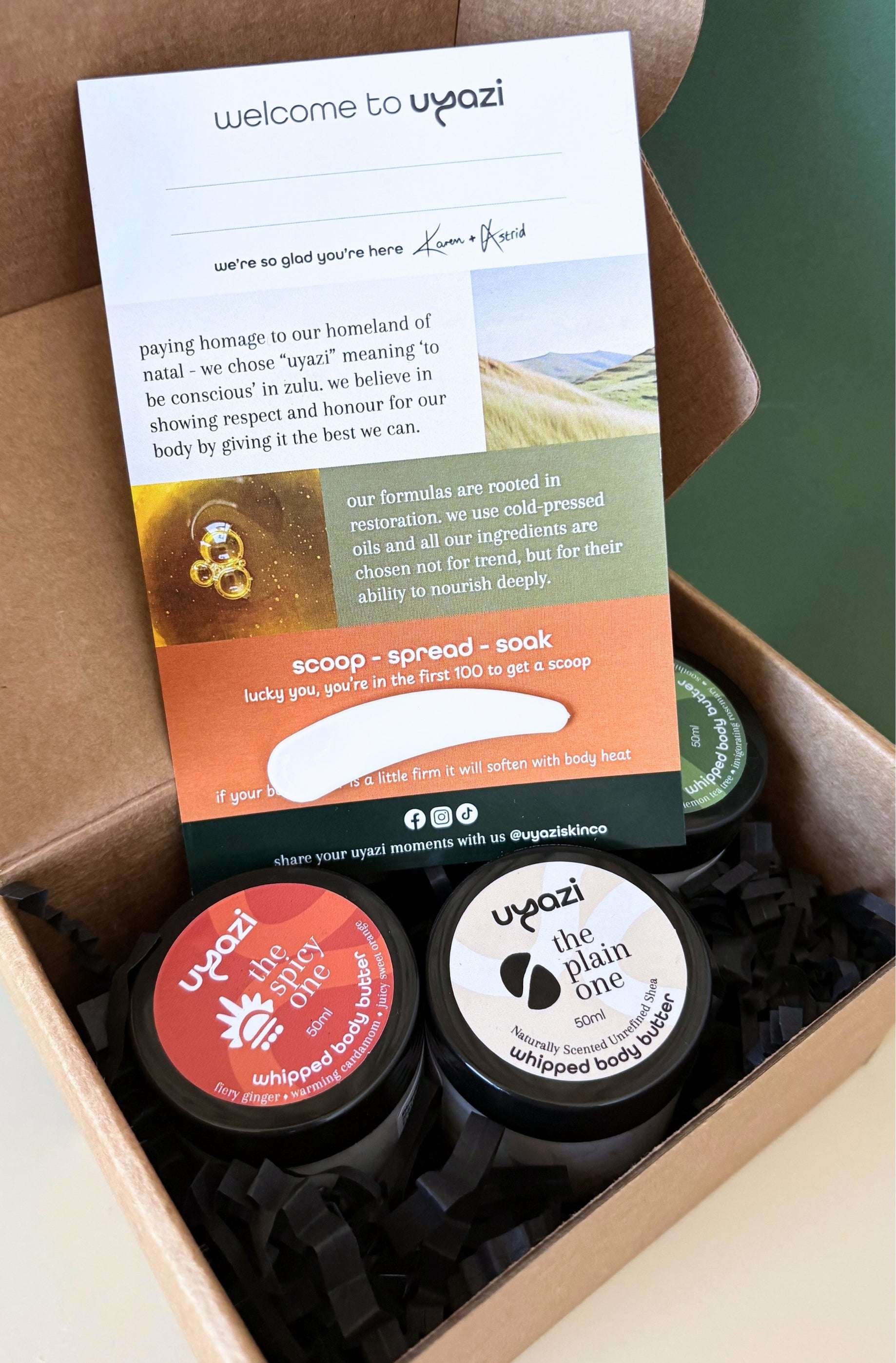 Uyazi body butter products with a product card in a box