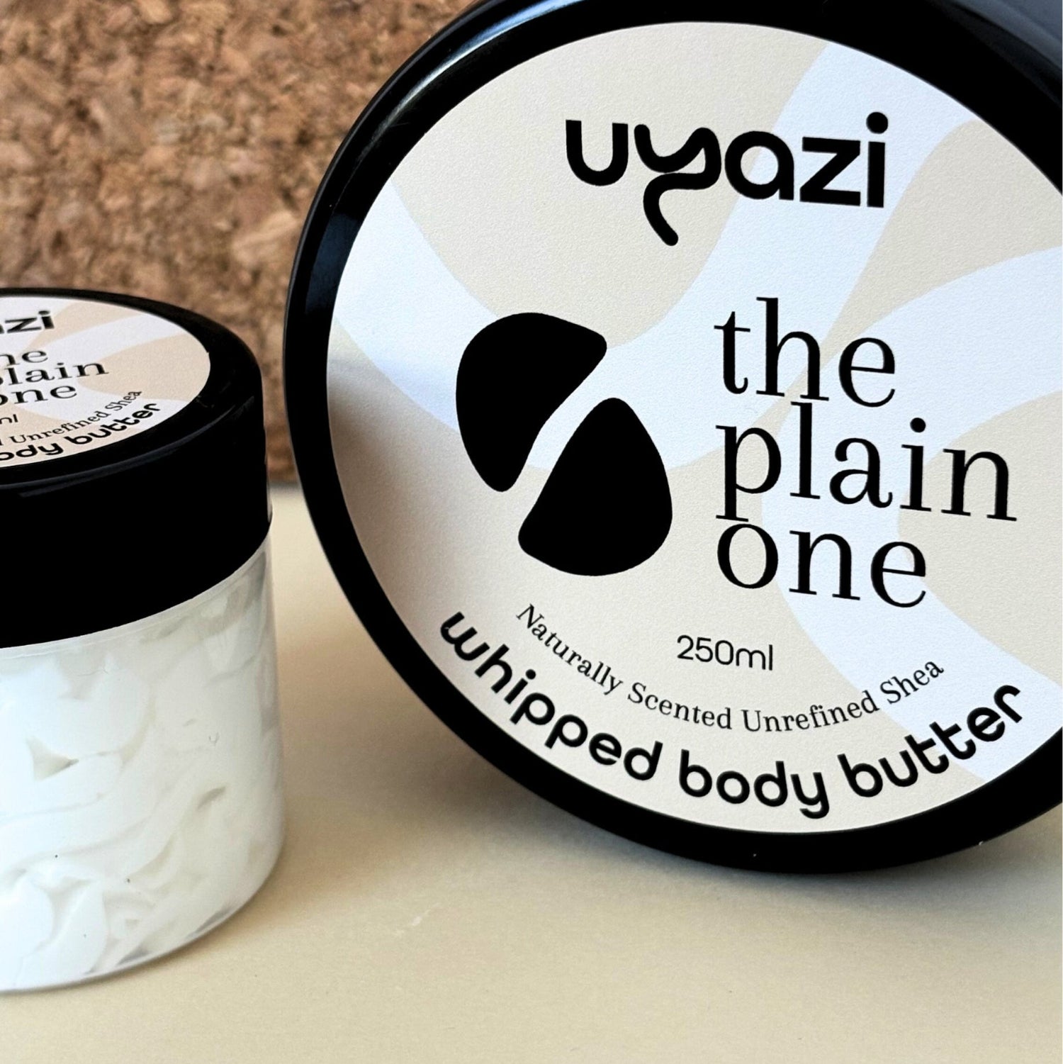 Two containers of Uyazi whipped body butter with unrefined shea