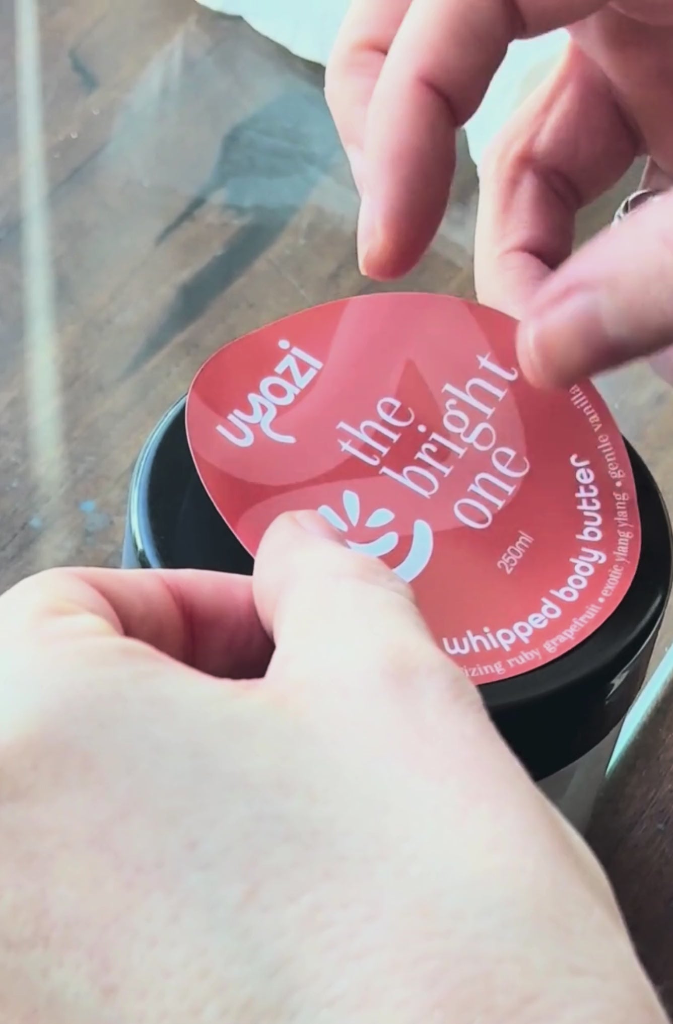 Video showing application of branding sticker to a whipped body butter 250ml jar