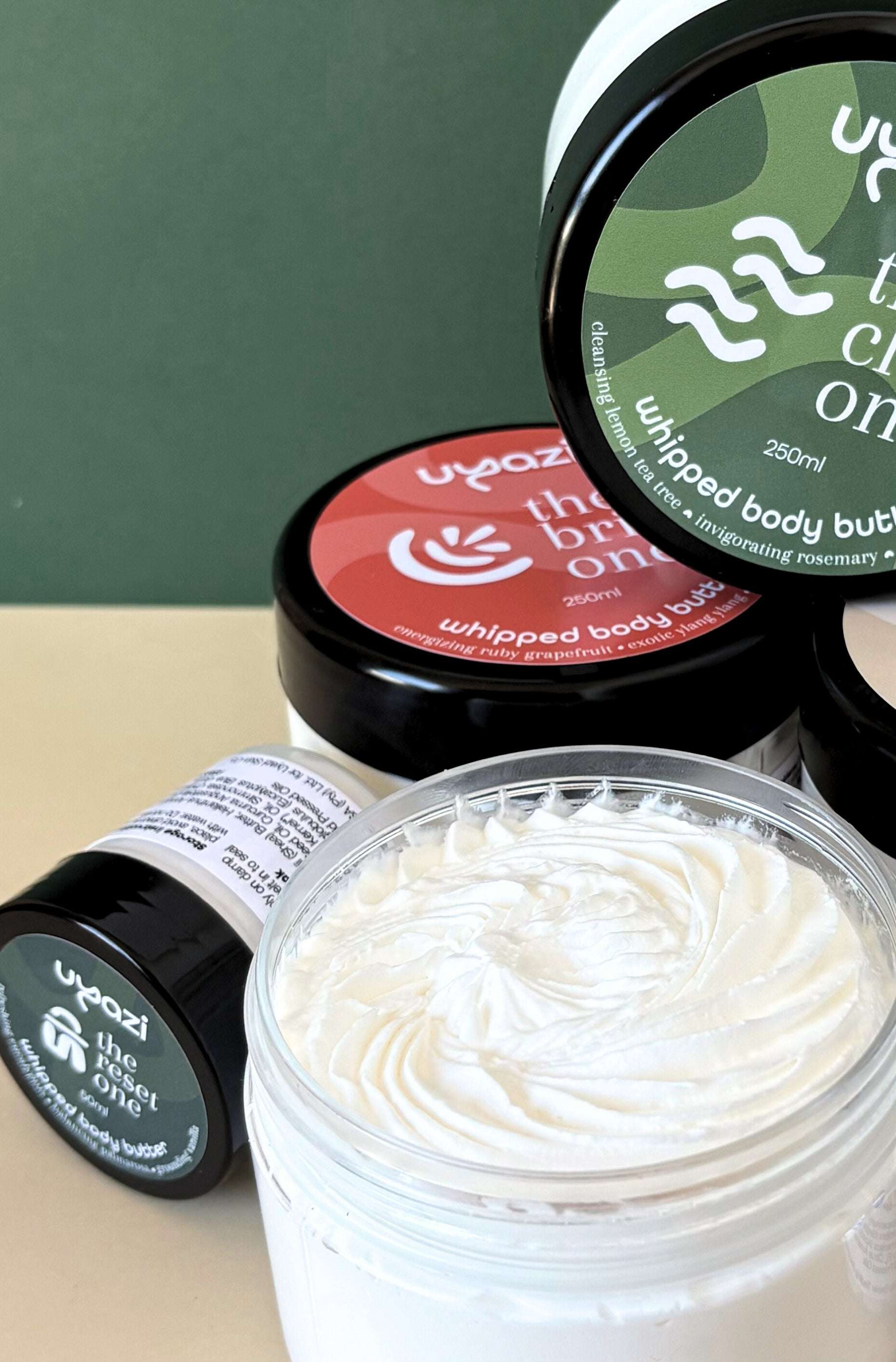 Whipped body butter with visible brand logo on a green background