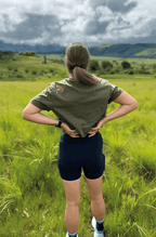 Braver woman wears a crop top with "she is stronger" design in the front