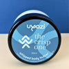 Uyazi whipped body butter 250ml container with blue label on a beige surface and blue background