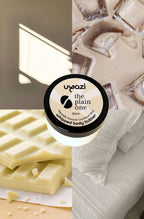Uyazi whipped body butter with white chocolate bars and a towel in the background